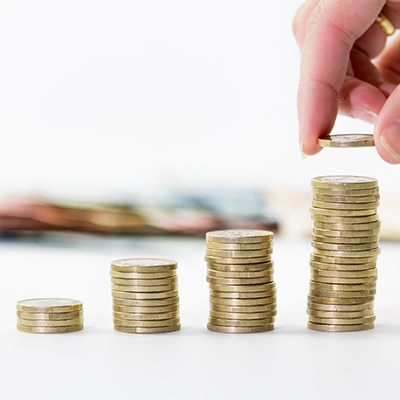 Stack of coins in decreasing order representing lower interest rate on loan against term deposit